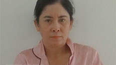 Đối tượng Trần Thị Loan tại cơ quan công an điều tra. (Ảnh: TTXVN phát) 