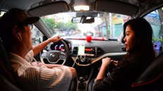 Hành khách sử dụng xe từ ứng dụng Uber tại TP.HCM - Ảnh: QUANG ĐỊNH