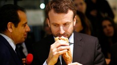 Tổng thống Pháp cầm bánh mì baguette. Ảnh: Reuters. 