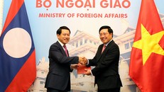 Phó Thủ tướng Phạm Bình Minh và Bộ trưởng Ngoại giao Lào Saleumxay Kommasith trao đổi Nghị định thư về đường biên giới và mốc quốc giới Việt Nam-Lào và Hiệp định về Quy chế quản lý biên giới và cửa khẩu biên giới Việt Nam-Lào. Ảnh: VGP/Hải Minh