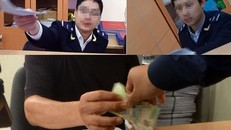 Hình ghi lại cảnh các cán bộ hải quan nhận "phí bôi trơn".Ảnh: Lao Động