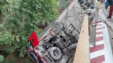 Chiếc xe bị lật ngửa suýt rơi xuống suối cạn. Ảnh: VnExpress