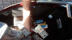 Nhiều tờ tiền bị cắt, ghép được phát hiện trong cốp xe của Nguyễn Thị Khẩn. Ảnh: CAO DIÊN