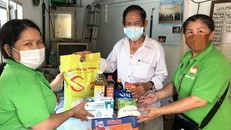 Bên cạnh việc chi hỗ trợ theo chính sách, người dân còn được nhận nhiều phần quà thiết yếu. (Ảnh: Thanh Vũ/TTXVN)