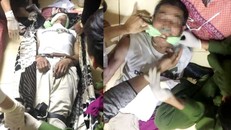 Sau khi đòi treo cổ, đối tượng tiếp tục đòi cắn lưỡi tự tử nên lực lượng chức năng đã khống chế đưa vào nhà sơ cứu. - Ảnh: Tiền Phong