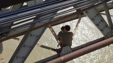 Người đàn ông ôm con nhỏ định nhảy cầu tự tử. - Ảnh: Dân Trí