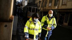 Người dân đeo khẩu trang, mặc đồ bảo hộ khi đi bộ ở trung tâm Lisbon, Bồ Đào Nha, ngày 25/11.