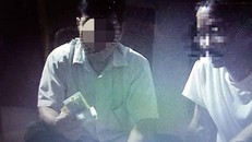 Hình ảnh ông H. đang cầm bài và cầm tiền trên chiếu bạc.