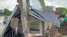 Một căn nhà kiên cố bị sụp xuống kênh Cái Sắn do sạt lở. Ảnh: TTXVN 