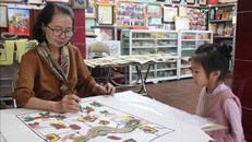 Nghệ nhân ưu tú Nguyễn Thị Oanh vẽ tranh rồng.