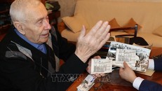 Trung tướng Porfiry Ivashko say sưa nói về từng bức ảnh. Ảnh: Hồng Quân/TTXVN