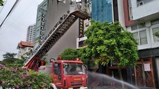 Lực lượng chức năng đang dập lửa và cứu người mắc kẹt bên trong. (Ảnh: Lao Động)