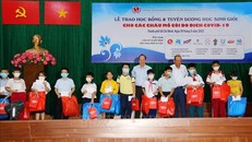 Ông Trương Hòa Bình, nguyên Phó Thủ tướng Thường trực Chính phủ cùng Phó Bí thư Thành ủy TP Hồ Chí Minh Nguyễn Hồ Hải trao học bổng cho các em mồ côi do dịch COVID-19. (Ảnh: TTXVN)