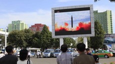 Người dân Triều Tiên theo dõi cảnh phóng tên lửa qua màn hình. Ảnh: AP