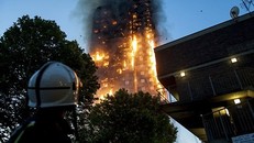  Lính cứu hỏa đứng phía dưới quan sát đám cháy tại tòa chung cư Grenfell, London. Ảnh: LNP