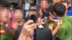 Chiến sỹ công an nghĩa vụ bị đám đông bao vây.