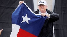 Tổng thống Trump vẫy lá cờ của tiểu bang Texas trong một cuộc vận động. Ảnh: AP.