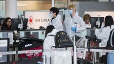 Du khách đeo khẩu trang phòng dịch COVID-19 tại sân bay quốc tế Pearson ở Toronto, Canada ngày 14/4/2020 - Ảnh: THX/TTXVN