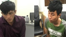 Hai nghi can Nguyễn Vũ Hoàng Nam (bên trái) và Trần Tuấn Anh tại cơ quan công an