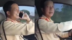 Hình ảnh vị cán bộ CSGT vừa lái xe vừa nghe điện thoại.