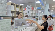 Người bệnh nhận thuốc bảo hiểm y tế tại quầy thuốc của bệnh viện. 