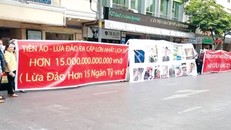 Người dân treo băng rôn tố cáo công ty lừa đảo tiền ảo. Ảnh: PV.
