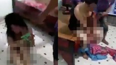 Đôi nam nữ không mảnh vải che thân bị bắt trói, đánh đập. Ảnh: Cắt từ clip
