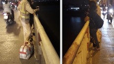 Hình ảnh Trung uý Hùng thuyết phục người phụ nữ định tự tử trên cầu Chương Dương 
