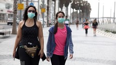 Người dân đeo khẩu trang phòng dịch COVID-19 khi di chuyển tại thành phố miền Trung Tel Aviv. (Ảnh: THX/TTXVN)