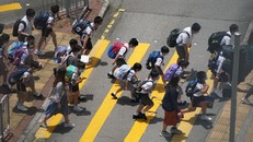 Học sinh Hồng Kông đang băng qua một con đường ở khu Tsuen Wan