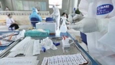 Nhân viên y tế lấy mẫu xét nghiệm cho người dân. (Ảnh: Minh Quyết/TTXVN)