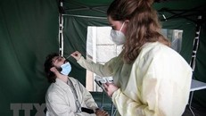 Nhân viên y tế lấy mẫu xét nghiệm COVID-19 cho người dân tại Paris, Pháp ngày 6/7/2022. (Ảnh: AFP/TTXVN)