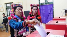 Đồng bào dân tộc Hà Nhì trong trang phục rực rỡ bỏ phiếu tại Tổ bầu cử số 1, xã Sín Thầu.