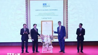 Ông Jonathan Wallace Baker, Trưởng Đại diện Tổ chức Giáo dục, Khoa học và Văn hóa của Liên hợp quốc (UNESCO) (bên phải) trao Bằng công nhận Công viên địa chất toàn cầu UNESCO Lạng Sơn cho lãnh đạo tỉnh Lạng Sơn. Ảnh: Anh Tuấn/TTXVN.