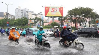 Các phương tiện lưu thông qua ngã tư Nguyễn Thị Nghĩa - Lê Lai, phường Bến Thành, bị ngập sâu trưa 6/10. Ảnh: Hồng Đạt.