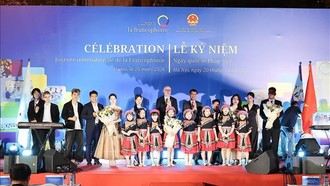 Ông Đặng Hoàng Giang, Thứ trưởng Bộ Ngoại giao và ông Pierre Du Ville, Trưởng đại diện Phái đoàn Wallonie-Bruxelles tại Việt Nam chụp ảnh lưu niệm với các bạn trẻ tham gia biểu diễn văn nghệ. Ảnh: Phạm Tuấn Anh