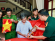 Ông Phan Văn Tư xúc động bên di ảnh hai người anh trai đã hy sinh. (Ảnh: Bộ Tư lệnh Thành phố Hồ Chí Minh cung cấp)