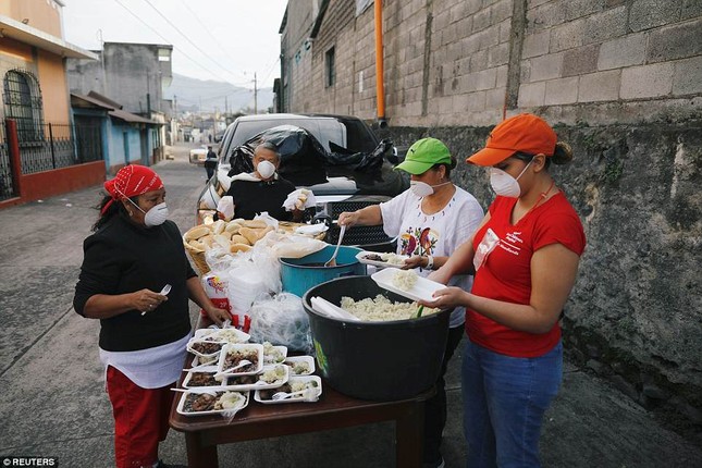 Volunteers are seen preparing food rations after Fuego volcano erupted in Alotenango, Guatemala, sparking new evacuations