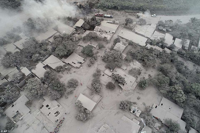 The fiery volcanic eruption in south-central Guatemala killed scores as rescuers struggled to reach people where homes and roads were charred and blanketed with ash