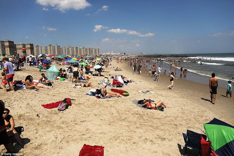 Up to 18 states have already issued heat advisories, according to the National Weather Service. People in New York City enjoy the beach out at Roackaway