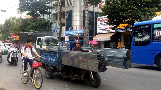 Xe ba gác chở sắt không bọc hai đầu chạy trên đường Lý Thường Kiệt (Q.11)