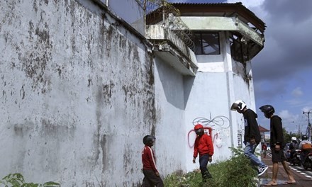 Người dân quan sát đường hầm trốn thoát bên ngoài nhà tù Kerobokan. 