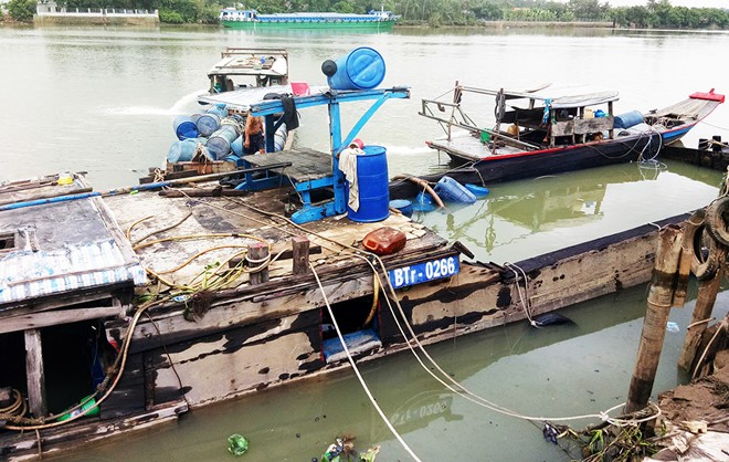 Chủ tàu dùng máy bơm hút nước khỏi khoang để vớt phương tiện. Ảnh: Ngọc An.