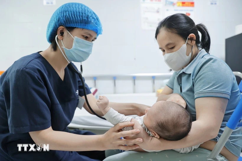 Bác sĩ khám cho bệnh nhi gần 2 tháng tuổi mắc ho gà điều trị tại Bệnh viện Nhi Trung ương. Ảnh: Minh Quyết/TTXVN.