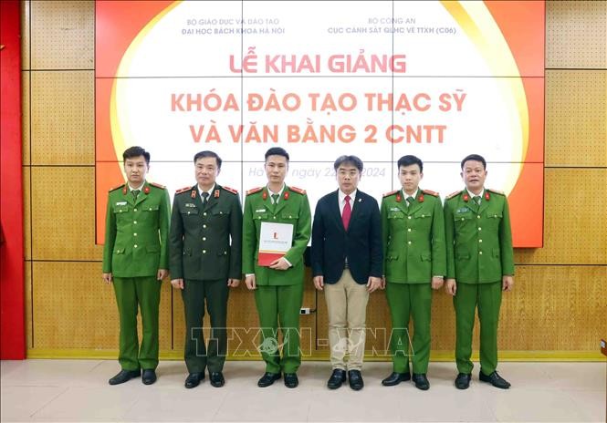 Lãnh đạo Bộ Công an và Đại học Bách Khoa Hà Nội trao quyết định công nhận Học viên cao học cho các học viên. Ảnh: TTXVN