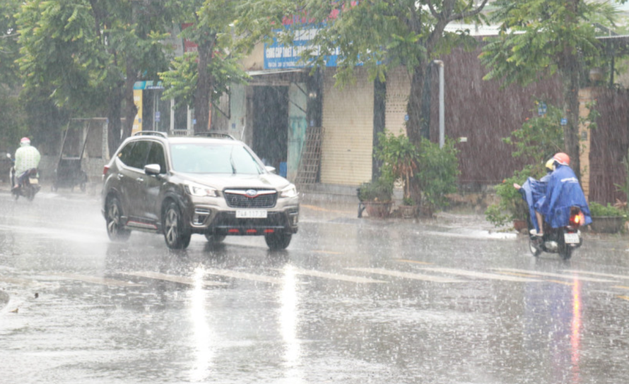 Người dân đi lại trong mưa lớn ở thành phố Đông Hà, tỉnh Quảng Trị.