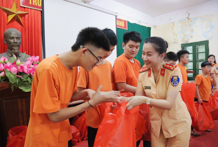 Bà Nguyễn Thị Hồng Nhung trao quà cho các em học sinh của trường PTCS dân lập dạy trẻ câm điếc Hà Nội. (Ảnh: Đỗ Phú)