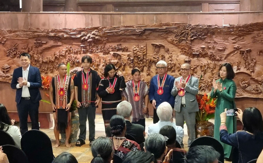 Ban tổ chức trao kỷ niệm chương cho các nghệ nhân tham gia chương trình.