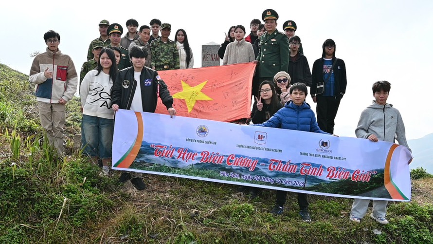 Đại diện học sinh hai tập thể lớp chụp ảnh lưu niệm tại mốc biên giới Việt - Lào. Ảnh: Nguyệt Linh